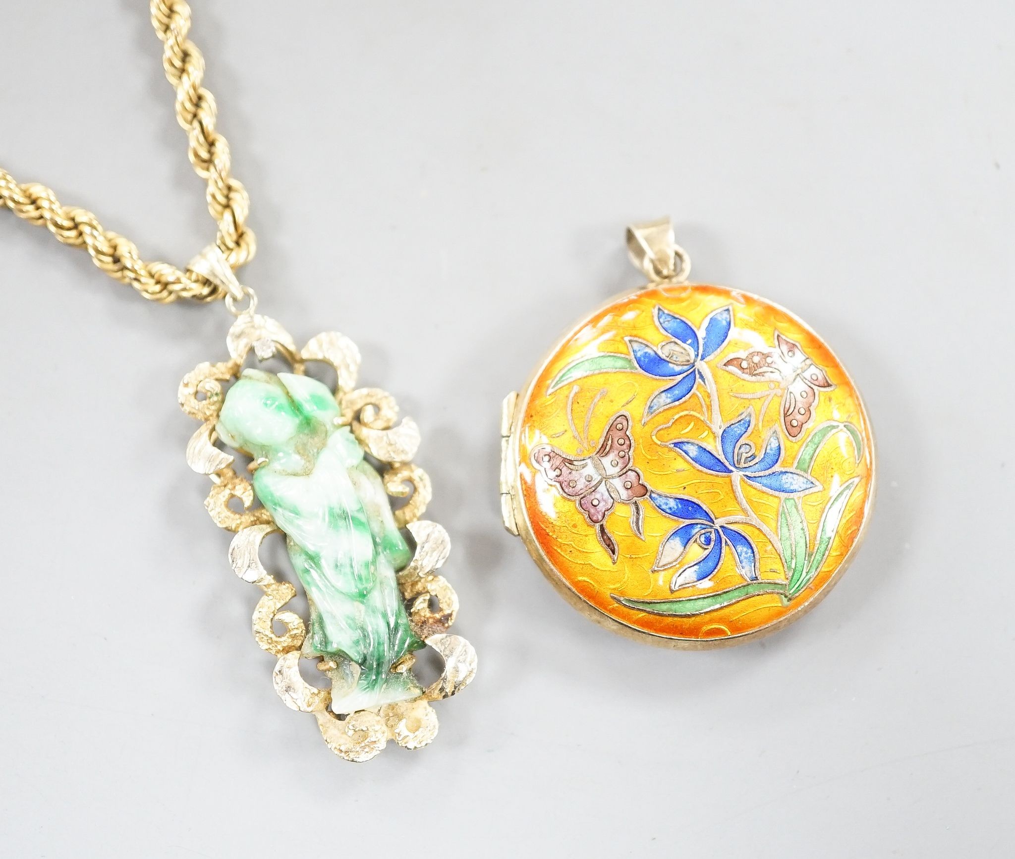 A 14k yellow metal and carved jade set pendant, 45mm, gross 8.5 grams, on a 9ct gold ropetwist chain, 56cm, 10.5 grams and an enamelled gilt white metal pendant.